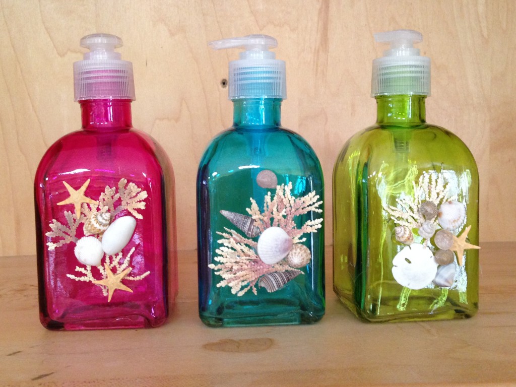 colored glass bottles decorated with seashells