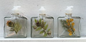 Soap and lotion dispensers decorated with pressed wild flowers. 