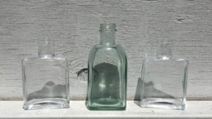 image of clear glass soap and lotion dispensers