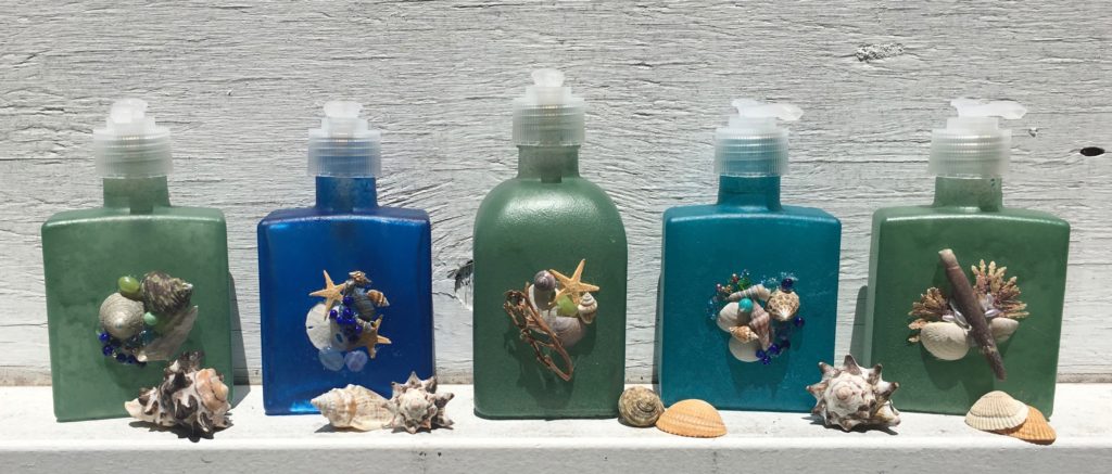 image of sea glass colored soap and lotion dispensers decorated with seashells and beads